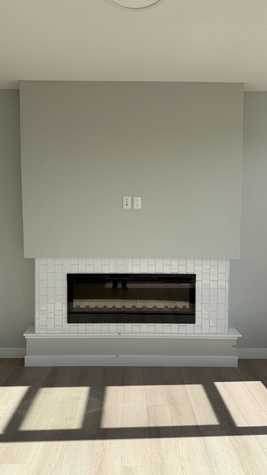 Finished fireplace wall in an Alliston home in Chestermere, painted by Enteco