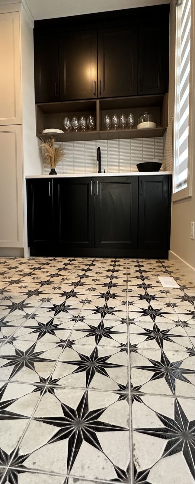 Finished entryway with patterned tile floor in an Alliston home in Cimarron
