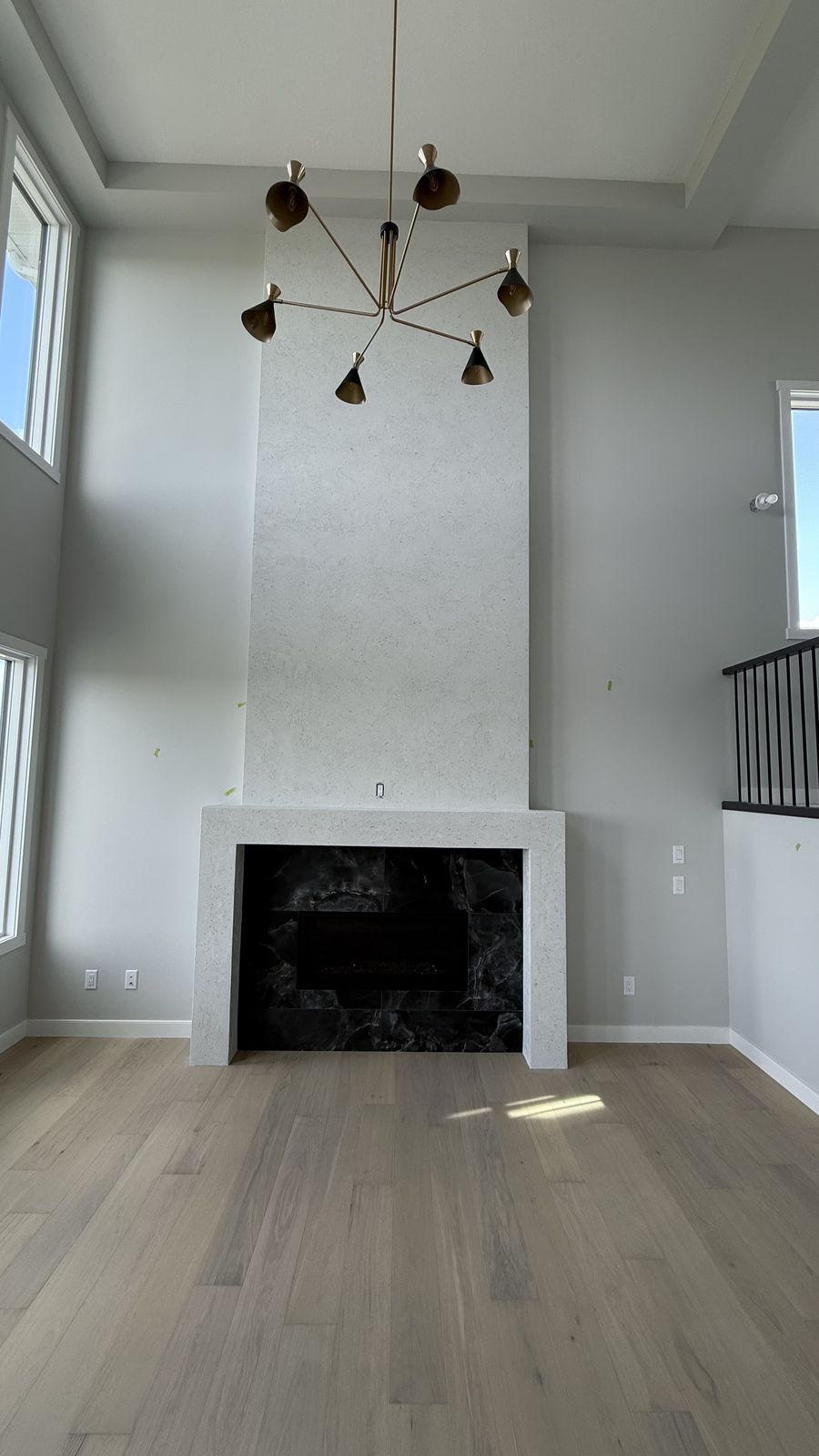 Two-storey great room with fireplace in an Alliston home in Cimarron, painted by Enteco