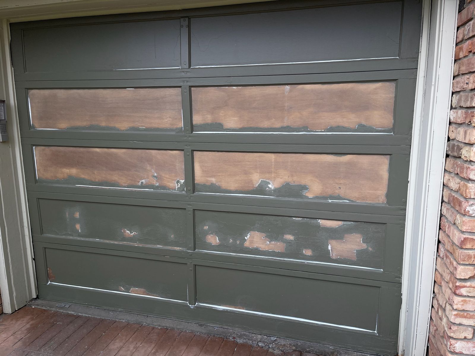 Weathered, peeling wood garage door before painting