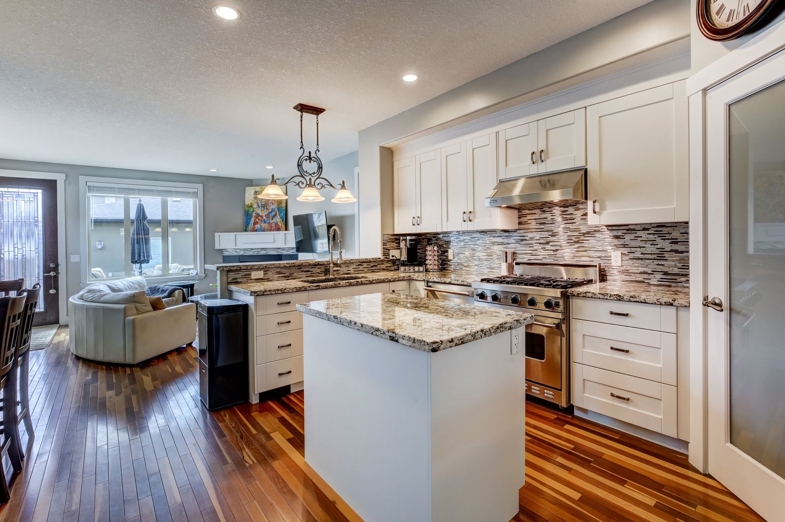 Same kitchen with bright white painted cabinets, NE Calgary