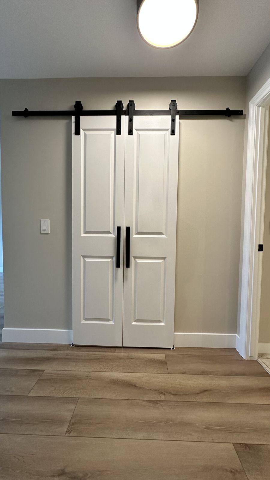 New barn doors installed in the renovated Calgary condo