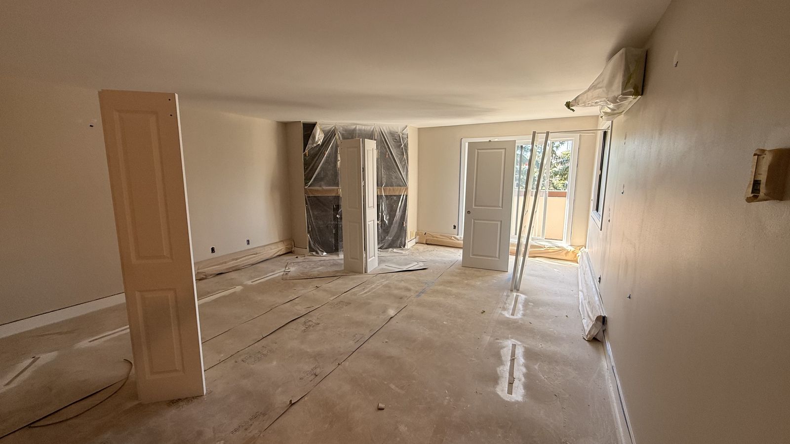 Calgary condo renovation in progress, drywall mudded and fireplace protected