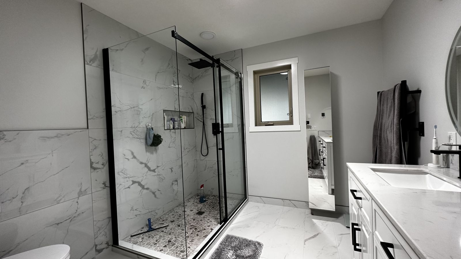 Same ensuite after remodeling, glass shower and dual vanity
