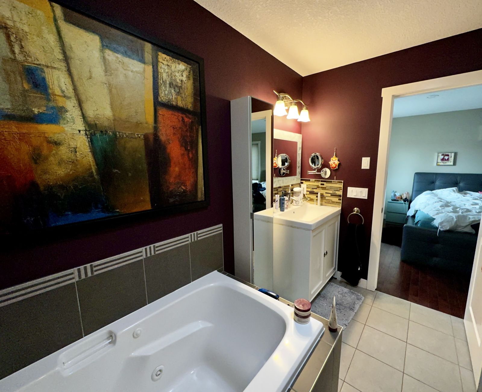 Dated ensuite bathroom before remodeling, maroon walls and jacuzzi tub