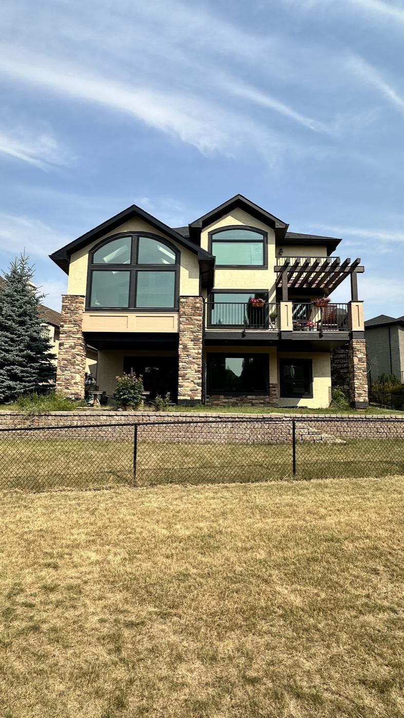 Same house exterior after repaint, cream stucco, Discovery Ridge