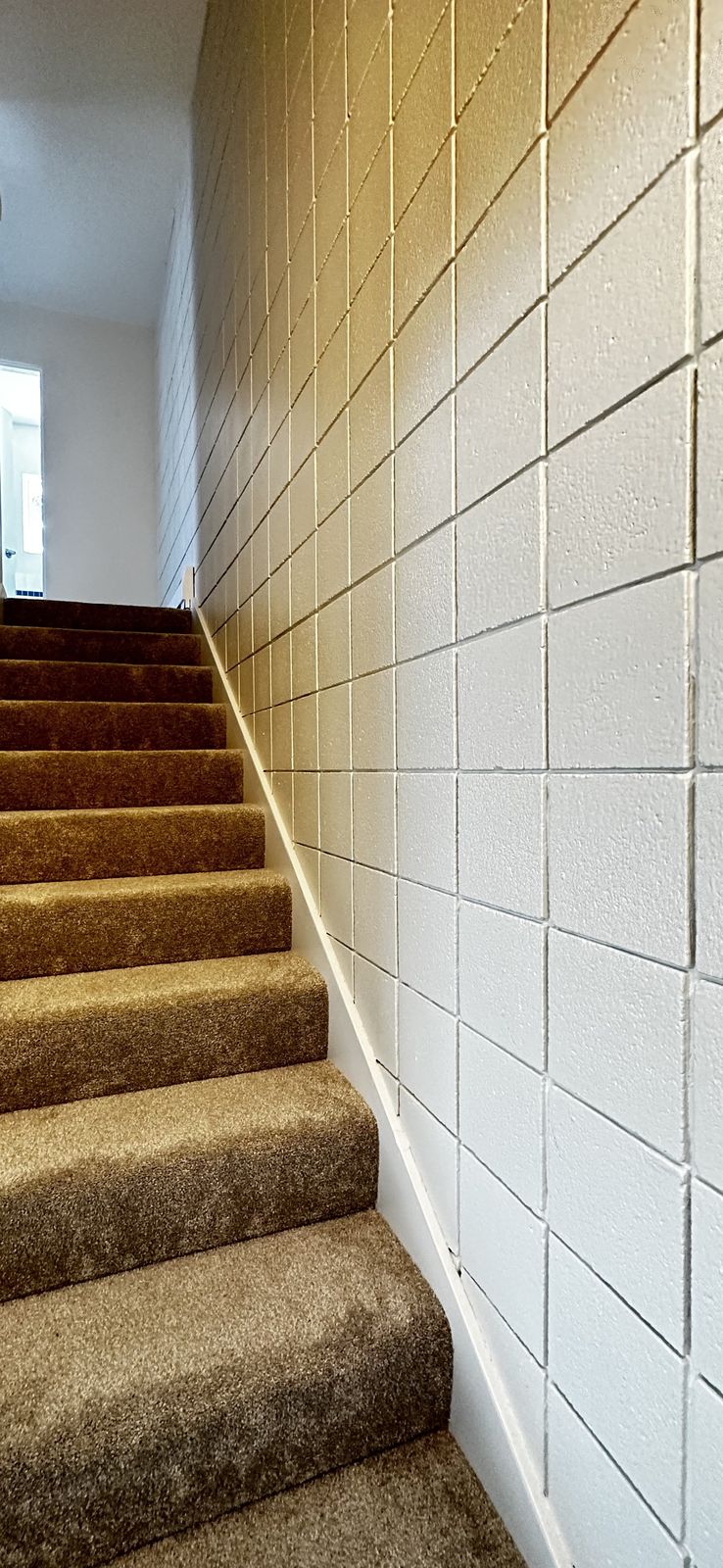 Same stairwell after painting, bright walls and stair runner, Elbow Drive SW