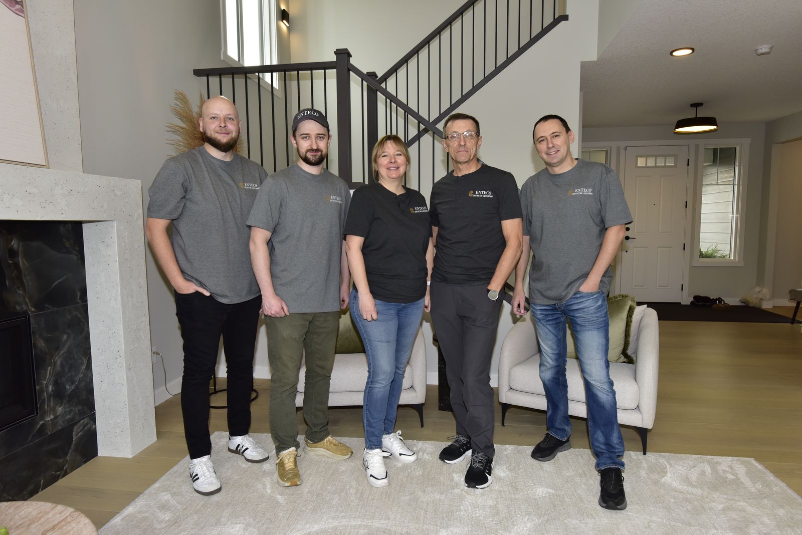 The Enteco crew together in a finished Calgary home