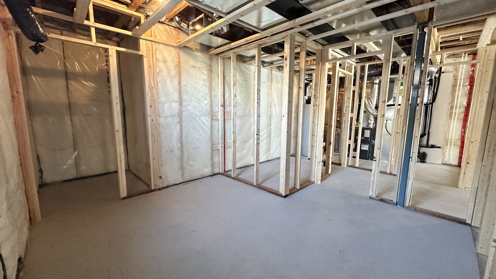 Basement before development, exposed framing and insulation, Legacy Woods