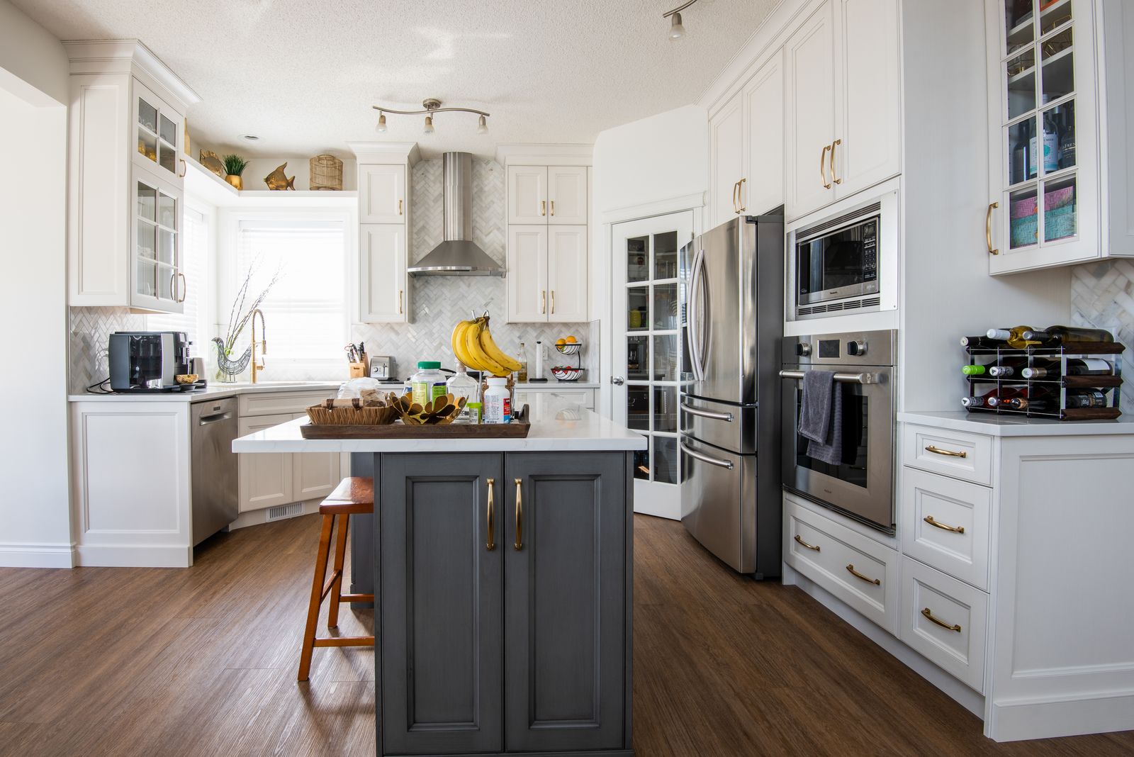 Same kitchen with white cabinets and charcoal island after remodeling, Tuscany