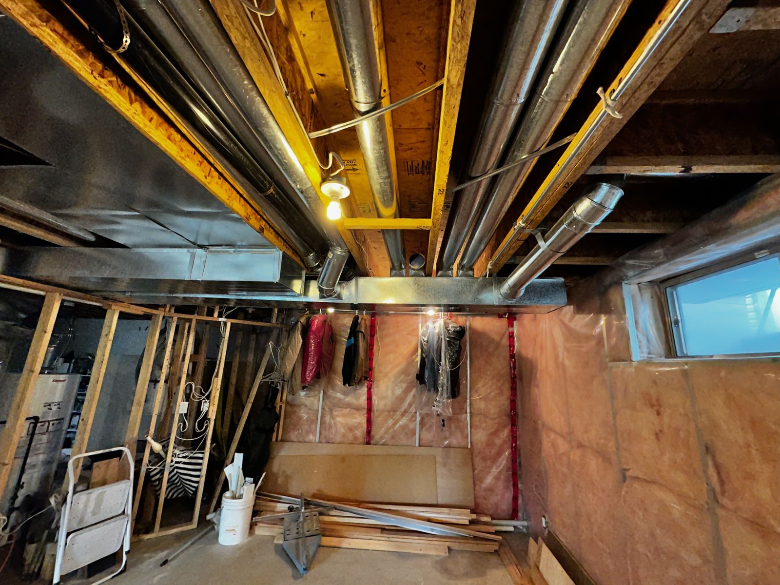 Basement before development, exposed ceiling and framing